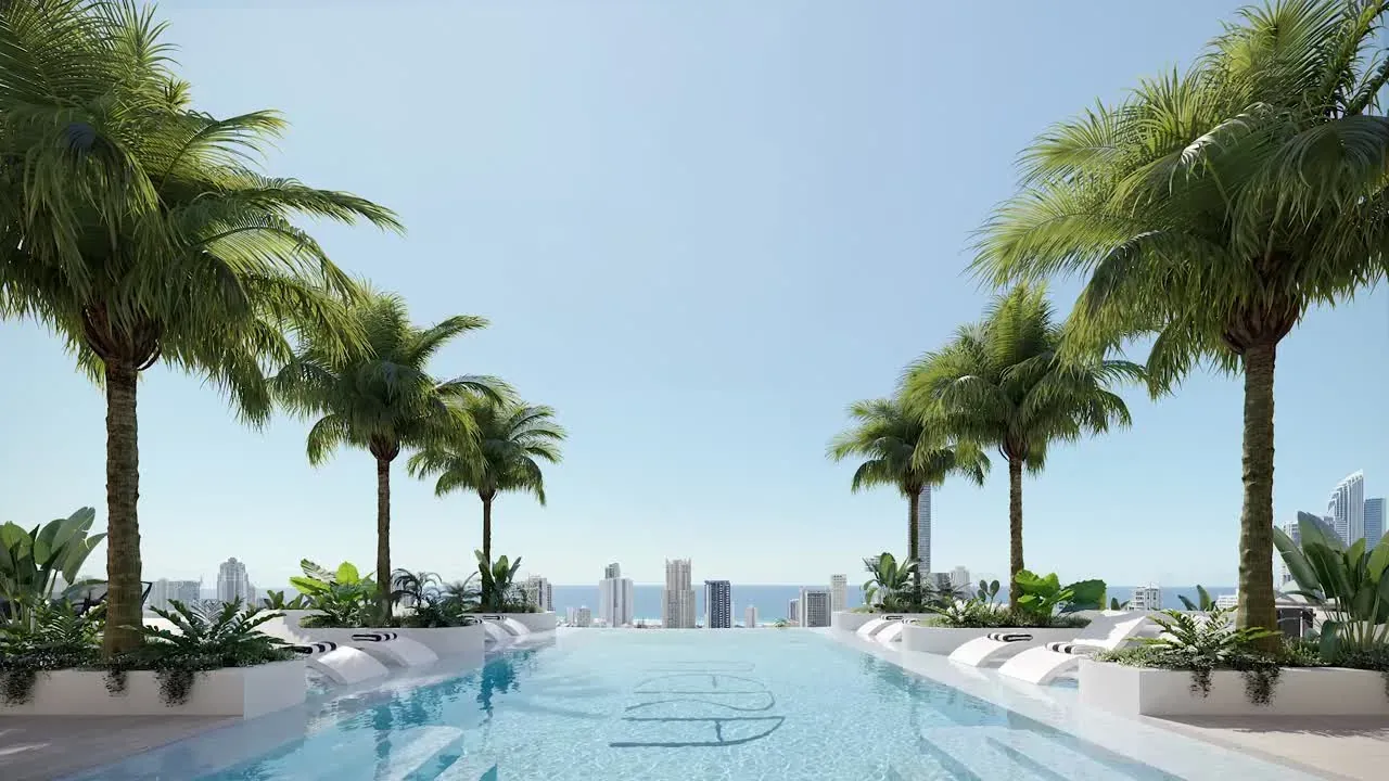Render of the Nera Residences rooftop infinity pool, lined with palms and looking out to the Surfers Paradise skyline and ocean